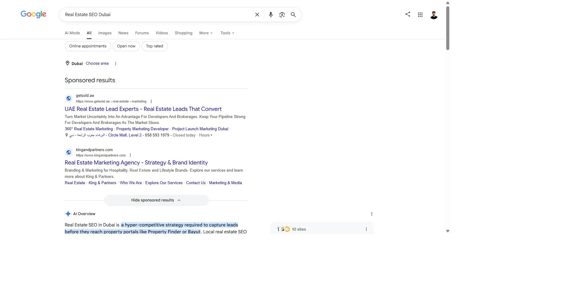 Google search results page showing sponsored ads, AI Overview, and organic competition for the keyword Real Estate SEO Dubai